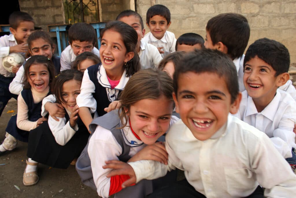 Image of 15 young children smiling and laughing.
